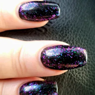 Black gel polish with 002 color glitter top coat.