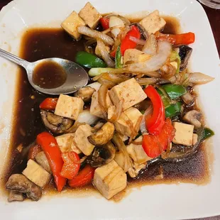 a plate of stir fried tofu and vegetables