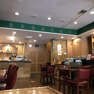 a view of a restaurant with tables and chairs