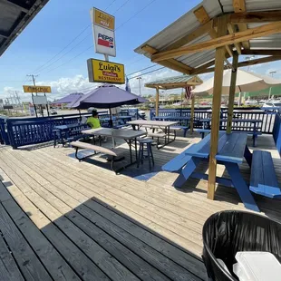 a deck with tables and umbrellas