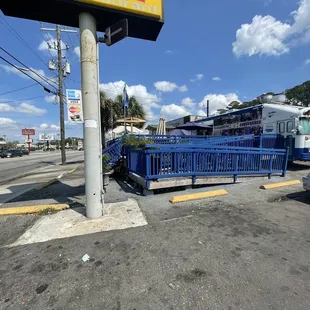 a blue shopping cart parked on the side of the road