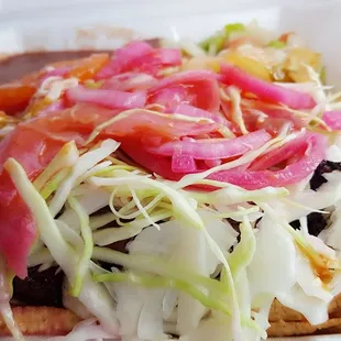 Carne Asada con Tajadas- there is steak and plantains under that mound.