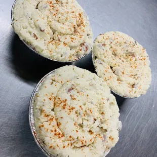 three pies in tins on a metal surface