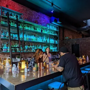 a group of people sitting at a bar