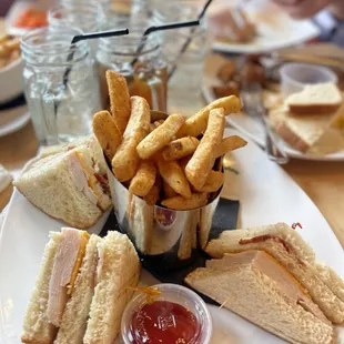 a plate of sandwiches and french fries