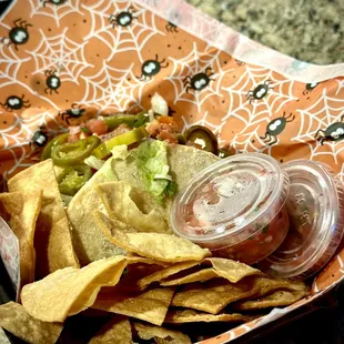 a tray of chips and salsa