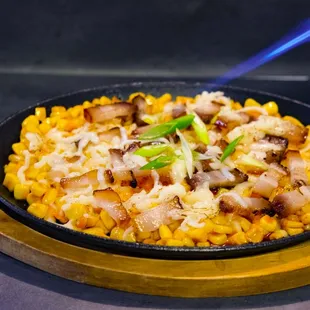 a skillet of food on a cutting board