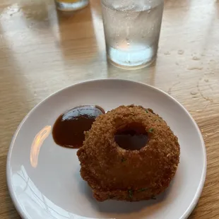 a closeup of a fried donut on a white plate