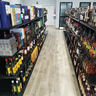 a wide aisle of liquor bottles