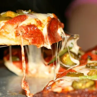 a slice of pizza being lifted by a spatula