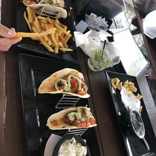 Cajun shrimp tacos with a side of fries and the huevos rancheros with a side of white cilantro rice