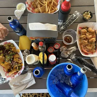 From l to r- beef nachos, shrimp Poboy sandwich, and fried mahi fries, and coleslaw.