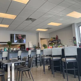 a restaurant with a bar and chairs