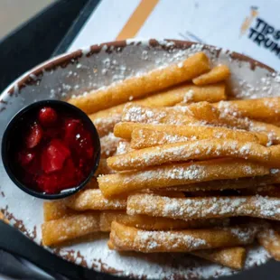 a plate of french fries and a bowl of ketchup