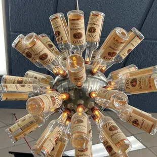 a chandelier made out of liquor bottles