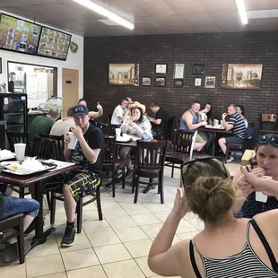 a group of people eating in a restaurant