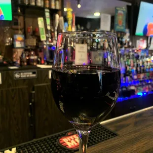 a glass of wine on a bar