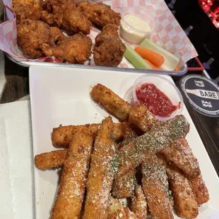 Fried zucchini sticks and chicken wings. On point