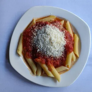 Penne pasta side with red sauce and a scoop of Parmesan.