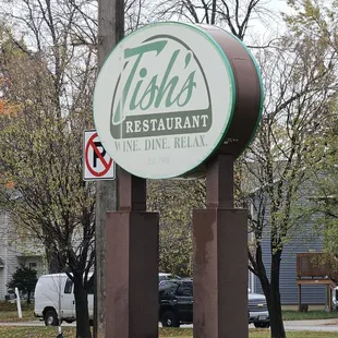 Outside - Main sign by the street right after the railroad bridge if you are coming that way.