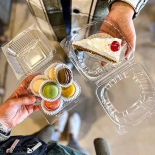 a person holding a piece of cake