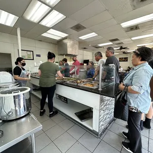 a group of people in a kitchen