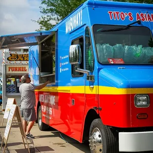 a man painting a food truck