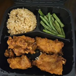 a meal of fried chicken, rice and green beans