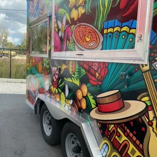 a colorful food truck parked in a parking lot