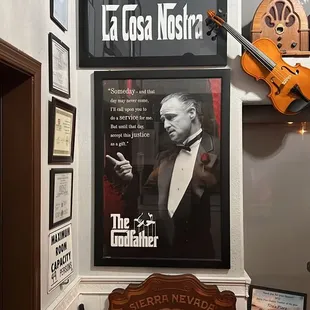 a wall with posters and a guitar