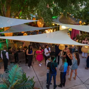 a group of people standing under a canopy