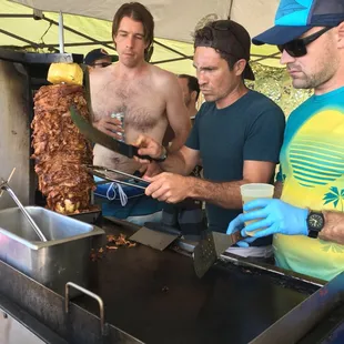 a group of men preparing food