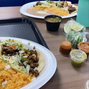 Tacos Asada , rice, refried beans, birria, guacamole and chips