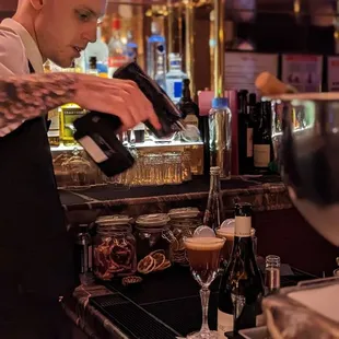 a bartender pouring a drink