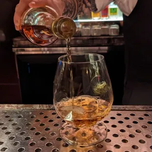 a bartender pouring a drink