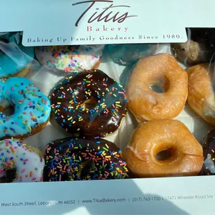 Sprinkled strawberry, blue dye, chocolate, glazed yeast donuts and blueberry cake donut