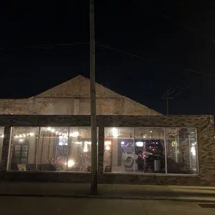 Large enclosed outdoor space with a flaming bath tub and a vintage truck