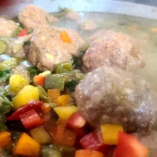 Meatballs on green tomatillo sauce with cactus