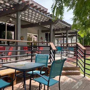 a patio with tables and chairs