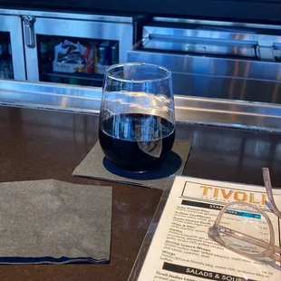 a glass of wine and menu