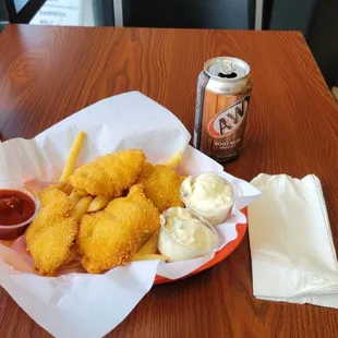 a basket of deep fried chicken nuggies with ketchup and ketchup