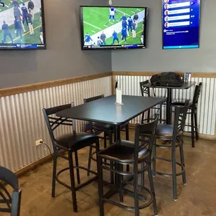 a table and chairs in a sports bar