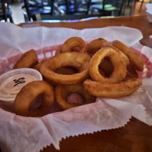 Crispy, delicious onion rings, yum!  Served with a spicy dipping sauce.