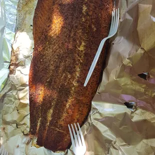 ows a piece of fish wrapped in foil