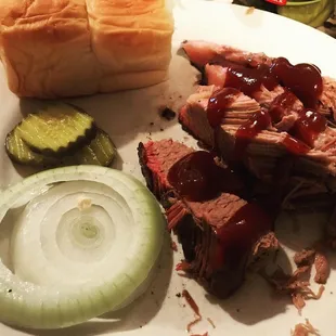 ows a pulled pork sandwich with barbecue sauce and pickles