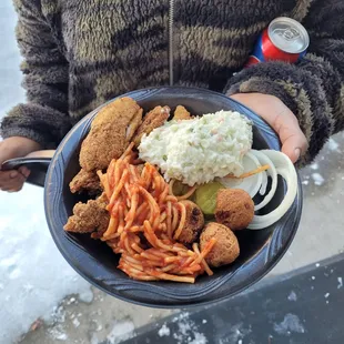 a person holding a plate of food
