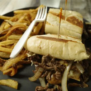 a steak sandwich and french fries