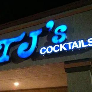 a neon sign above the entrance