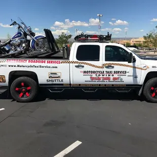 Motorcycle taxi service vehicle with motorcycle lift on back.