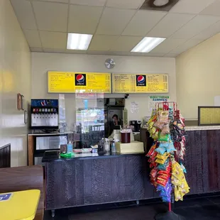 a woman in a colorful dress at the counter
